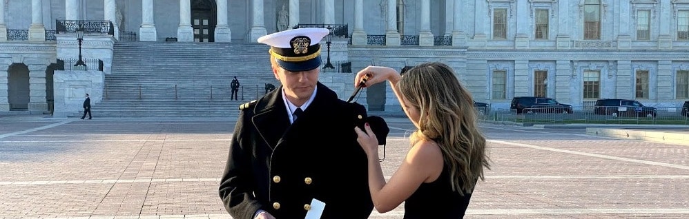 Sam receiving a Naval pin from his wife Elanda